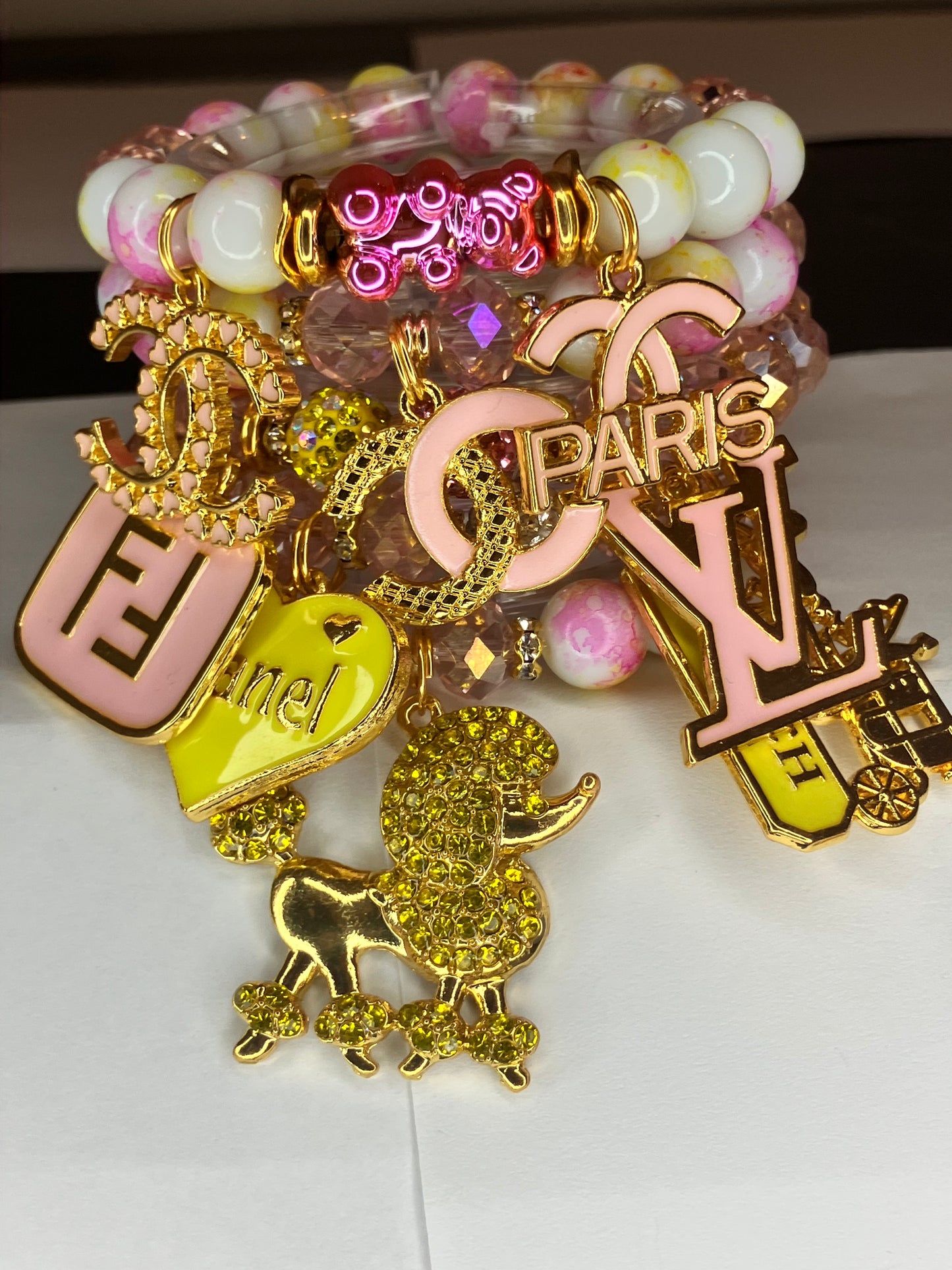 4 piece pink and yellow beadedcharm bracelet set.