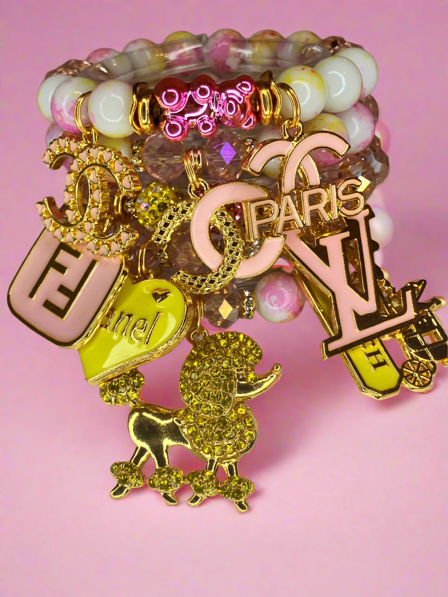 4 piece pink and yellow beadedcharm bracelet set.