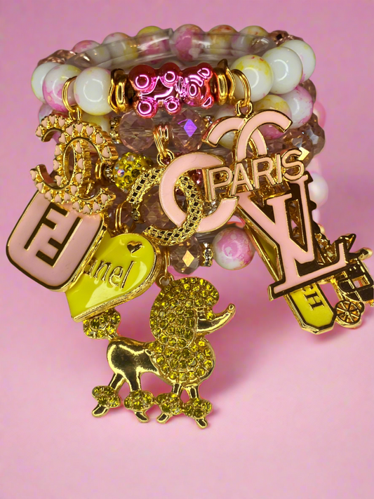 4 piece pink and yellow beadedcharm bracelet set.