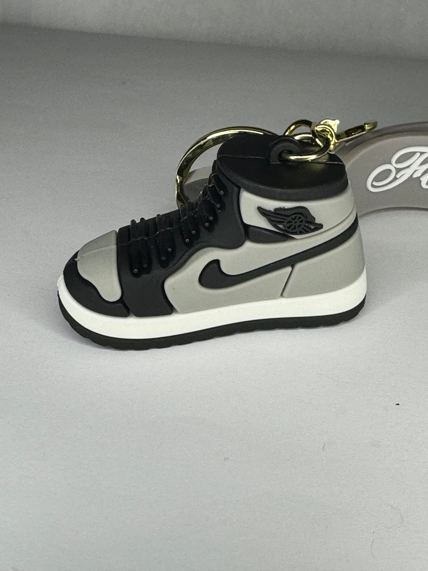 Black and gray Nike keychain